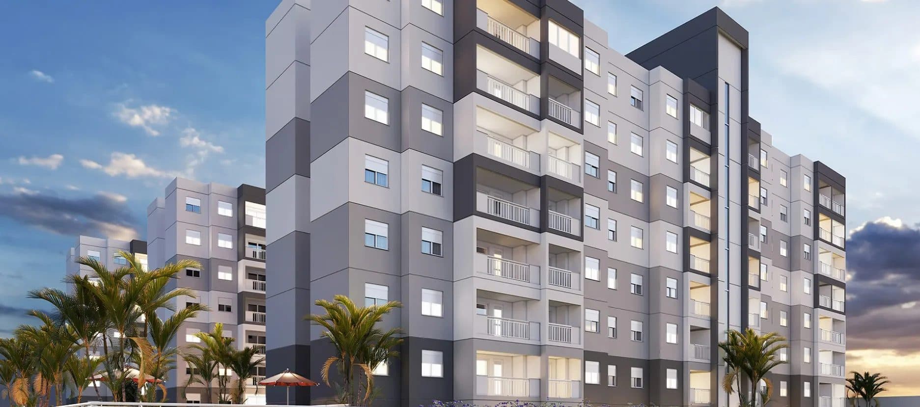 Fachada externa do edifício com pintura em tons de cinza e branco e varandas.